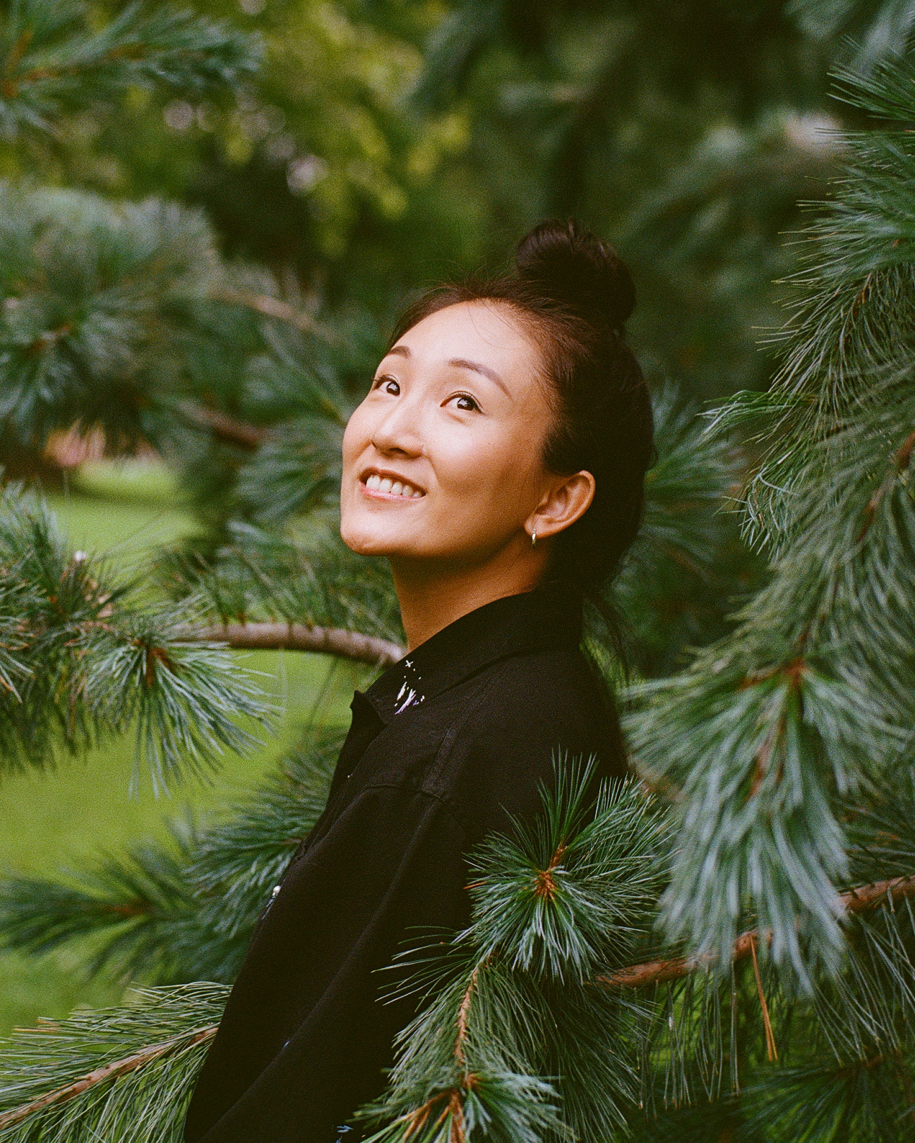 Portrait of Joy Mao standing amidst foliage